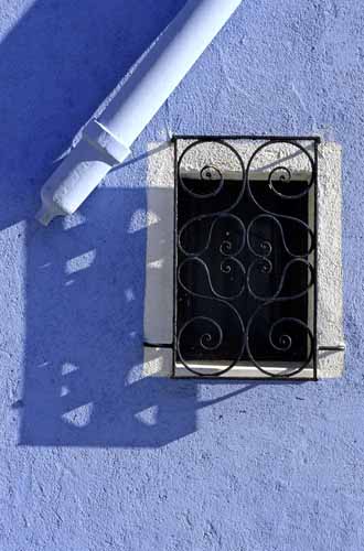 A black wrought iron on a azure wall - Burano in Venice, JBLArts photography